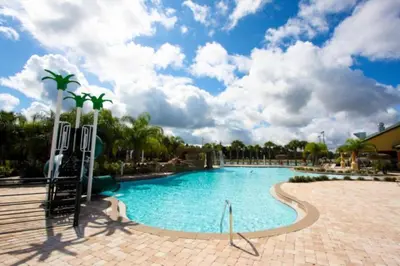a large swimming pool in a resort under a cloudy sky at Orlando Villa 6256: Experience 5-Star Luxury at Paradise Palms Resort in Kissimmee