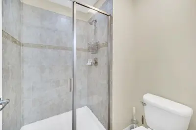 a bathroom with a glass shower with a toilet at Orlando Villa 6256: Experience 5-Star Luxury at Paradise Palms Resort in Kissimmee