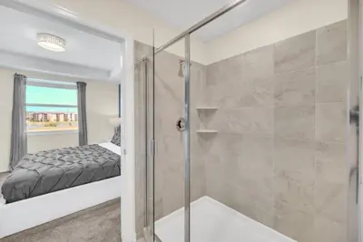 a bathroom with a shower and a glass shower stall at Orlando Condo 6259: Ultimate Family Retreat on Storey Lake in Kissimmee