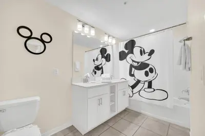 a bathroom with a mickey mouse mural on the wall at Orlando Condo 6259: Ultimate Family Retreat on Storey Lake in Kissimmee