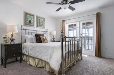 a bedroom with a bed and a ceiling fan at 5 Star Mansion with Private Pool on Formosa Gardens Orlando Manion 5075 in Orlando