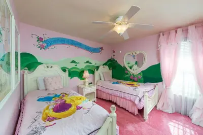 a childs bedroom with two beds and a ceiling fan at 5 Star Mansion with Private Pool on Formosa Gardens Orlando Manion 5075 in Orlando