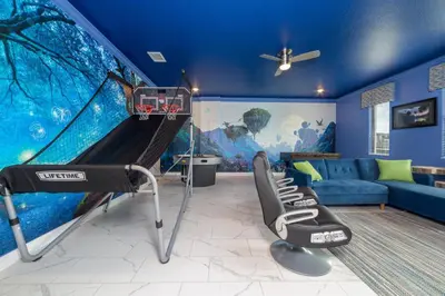 a room with a gym with a swing and a couch at The Ultimate Mansion with Private Pool on Storey Lake Resort Orlando Mansion 5287 in Kissimmee
