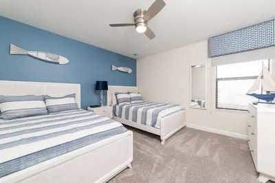 a bedroom with two beds and a ceiling fan at The Ultimate Mansion with Private Pool on Storey Lake Resort Orlando Mansion 5287 in Kissimmee