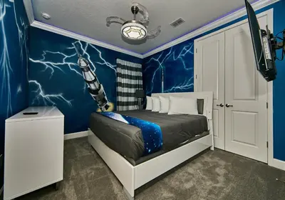 a bedroom with a room with a bed and a blue wall at 5 Star Mansion with Private Pool on Veranda Palms Orlando Mansion 5377 in Kissimmee