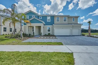 a large blue house with a garage at 5 Star Mansion with Private Pool on Veranda Palms Orlando Mansion 5377 in Kissimmee