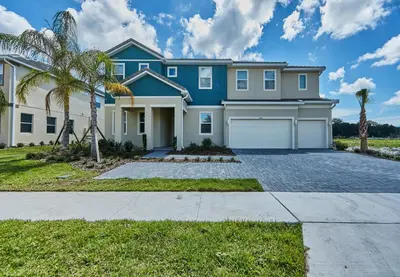 a large blue house with palm trees in front of it at 5 Star Mansion with Private Pool on Veranda Palms Orlando Mansion 5377 in Kissimmee