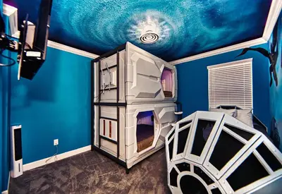 a bedroom with a blue wall and a bed and a room with at 5 Star Mansion with Private Pool on Veranda Palms Orlando Mansion 5377 in Kissimmee