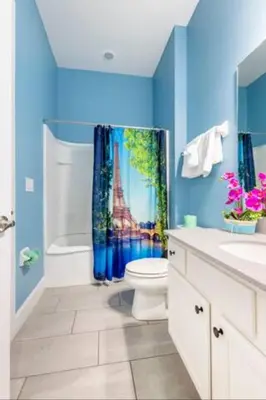 a bathroom with a toilet and a shower curtain at Exclusive Mansion with Large Private Pool on Veranda Palms Orlando Mansion 5378 in Kissimmee