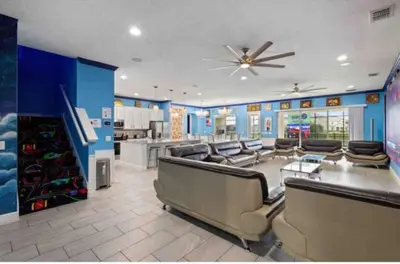 a large living room with couches and a ceiling fan at Exclusive Mansion with Large Private Pool on Veranda Palms Orlando Mansion 5378 in Kissimmee