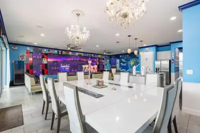 a dining room with a large white table and chairs at Exclusive Mansion with Large Private Pool on Veranda Palms Orlando Mansion 5378 in Kissimmee