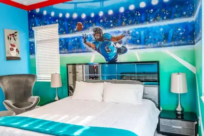 a bedroom with a football player mural on the wall at Perfect Mansion on Veranda Palms Orlando Mansion 5379 in Kissimmee