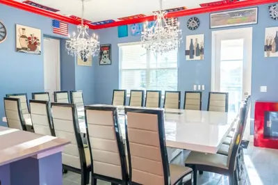 a dining room with a white table and chairs at Perfect Mansion on Veranda Palms Orlando Mansion 5379 in Kissimmee