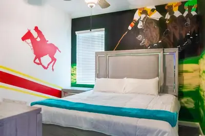 a bedroom with a bed with a horse on the wall at Perfect Mansion on Veranda Palms Orlando Mansion 5379 in Kissimmee