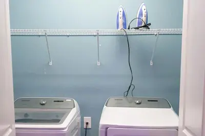 a bathroom with a washing machine and a drying rack at Perfect Mansion on Veranda Palms Orlando Mansion 5379 in Kissimmee