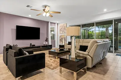 a living room with two couches and a flat screen tv at Beautiful Mansion with first class amenities on Solara Resort Orlando Mansion 5715 in Orlando