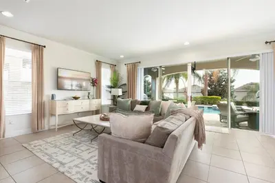 a living room with a couch and a table at Unleash Your Dreams in a Magical Getaway in Orlando
