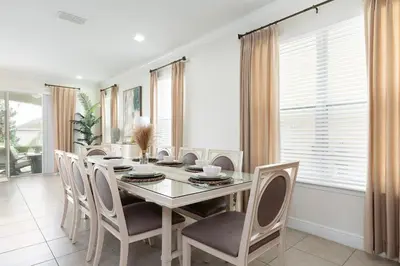 a dining room with a table and chairs at Unleash Your Dreams in a Magical Getaway in Orlando