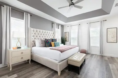 a bedroom with a bed and a ceiling fan at Unleash Your Dreams in a Magical Getaway in Orlando