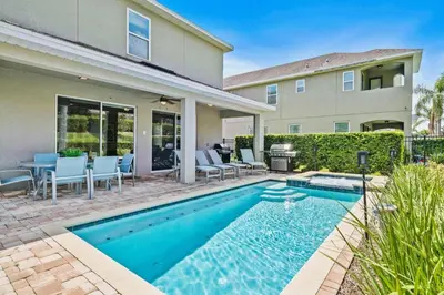 a swimming pool in front of a house at Experience Magic and Luxury Just Minutes from Disney in Orlando