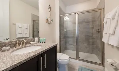 a bathroom with a shower and a sink and a toilet at Dive into Luxury and Fun at Your Orlando Paradise in Orlando
