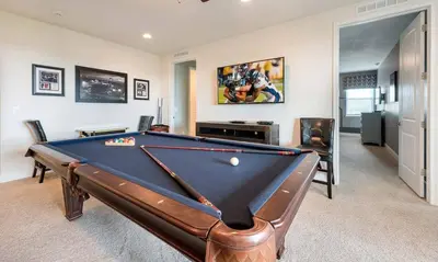 a pool table in a living room with a pool at Dive into Luxury and Fun at Your Orlando Paradise in Orlando