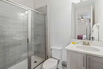 a bathroom with a shower and a toilet and a sink at Indulge in Opulence: Where Comfort Meets Endless Fun in Orlando