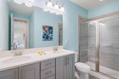a bathroom with two sinks and a shower at Indulge in Opulence: Where Comfort Meets Endless Fun in Orlando