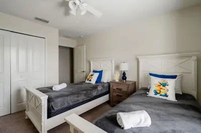 a bedroom with two beds and a ceiling fan at Outdoor Movie Theatre! Heated Private Pool! 4 Mi to Disney! Grill in Kissimmee