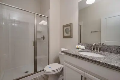 a bathroom with a shower and a toilet and a sink at Outdoor Movie Theatre! Heated Private Pool! 4 Mi to Disney! Grill in Kissimmee