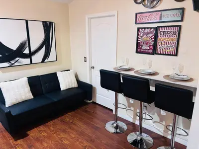 a living room with a couch and a bar at Luxury Apartment with Lake view in Orlando