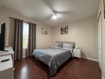 a bedroom with a bed and a ceiling fan at Luxury Apartment with Lake view in Orlando