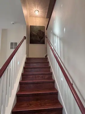 a staircase in a house with a painting on the wall at Luxury Apartment with Lake view in Orlando