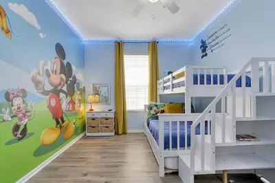 a bedroom with a mickey mouse mural on the wall at The Perch-2 Miles from Disney, Movie Theatre & Water Park in Orlando