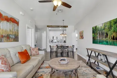 a living room with a couch and a table at The Perch-2 Miles from Disney, Movie Theatre & Water Park in Orlando