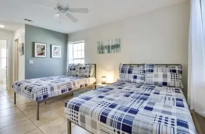 a bedroom with two beds and a ceiling fan at Florida Gem in Kissimmee