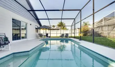 an indoor swimming pool with a glass ceiling and a swimming poolvisor at Florida Gem in Kissimmee