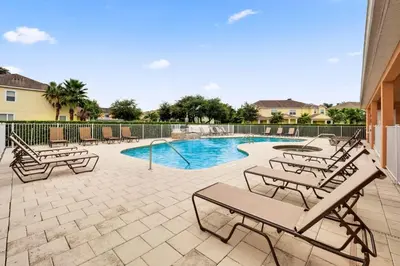 a swimming pool with chaise lounge chairs and a swimming pool at TR1421SL - Brand new Mykonos property in Orlando