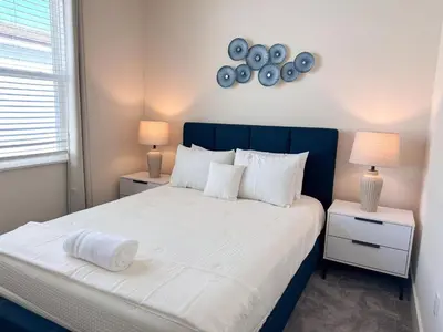 a bedroom with a bed with two night stands and two lamps at TR1421SL - Brand new Mykonos property in Orlando