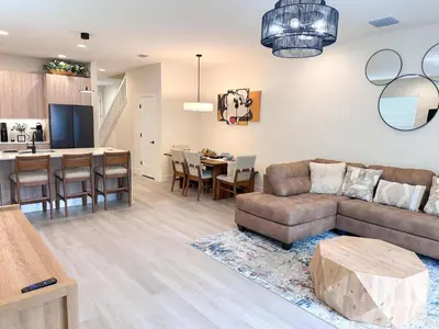 a living room and kitchen with a couch and a table at TR1461SL - 4 bedrooms pool home - 10 guests in Orlando
