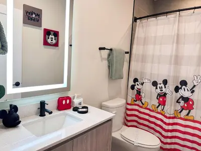 a bathroom with a mickey mouse shower curtain at TR1461SL - 4 bedrooms pool home - 10 guests in Orlando