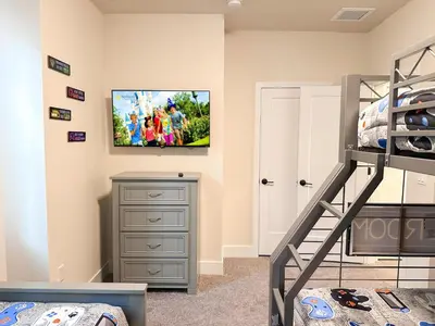 a bedroom with a bunk bed and a tv on the wall at TR1461SL - 4 bedrooms pool home - 10 guests in Orlando