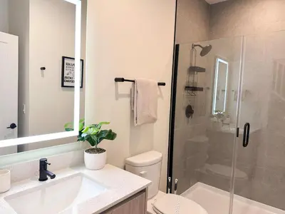 a bathroom with a shower and a toilet and a sink at TR1461SL - 4 bedrooms pool home - 10 guests in Orlando