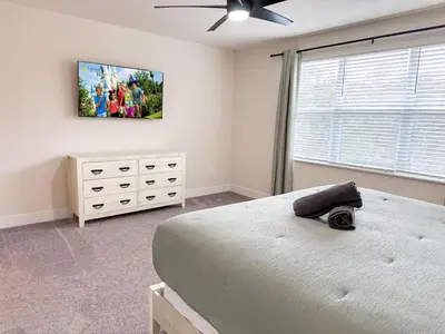 a bedroom with a bed and a tv on the wall at TR1461SL - 4 bedrooms pool home - 10 guests in Orlando