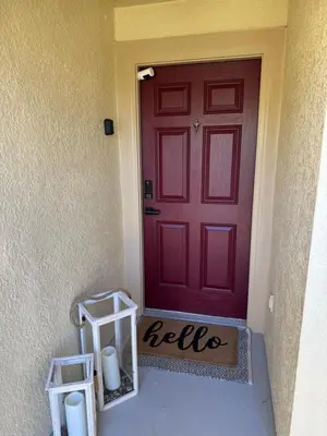 a red door with two candles in front of it at Family stay Near Disney in Kissimmee