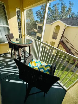 a porch with a table and a chair and a table at Family stay Near Disney in Kissimmee