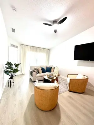 a living room with a couch and a ceiling fan at Family stay Near Disney in Kissimmee