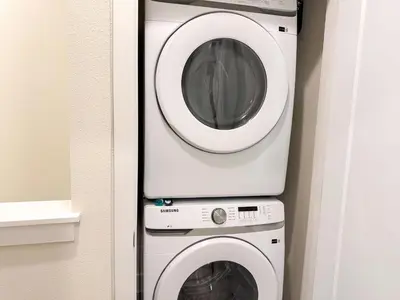 a washing machine and a dryer in a room at TR1399 – 4BR - 8 guests in Orlando