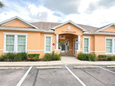 a building with the entrance to a courthouse at TR1391 – 4 Bedrooms Home with pool near Disney in Clermont