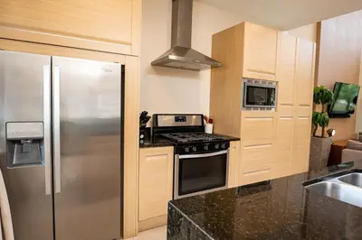 a kitchen with a stove and a refrigerator at Disney Escape Modern 3BR Townhouse 2 Miles to the Parks 4 Baths in Orlando
